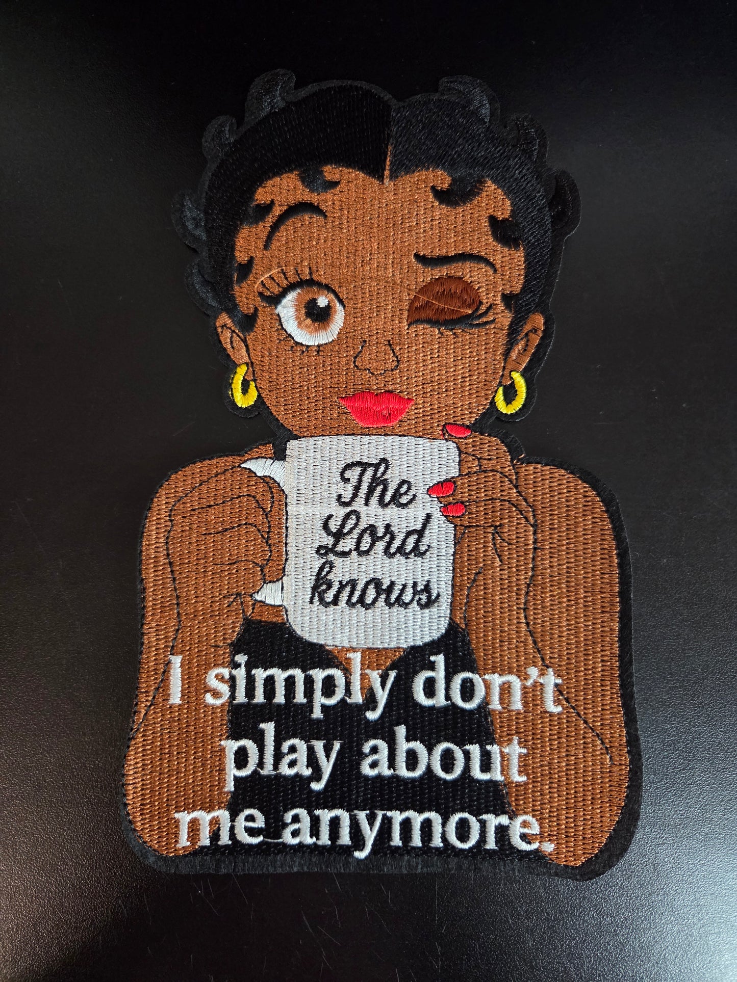 Winking Betty - The Lord Knows Iron On Patch