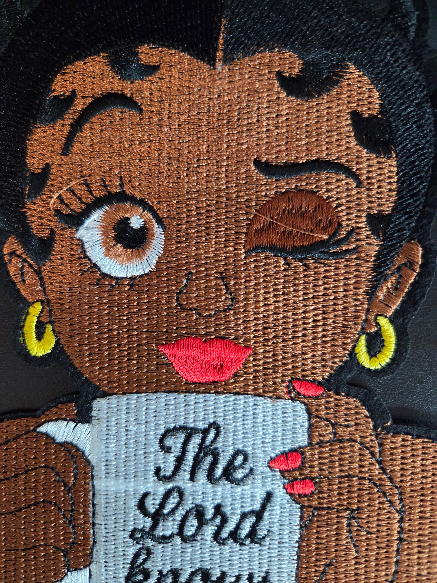 Winking Betty - The Lord Knows Iron On Patch